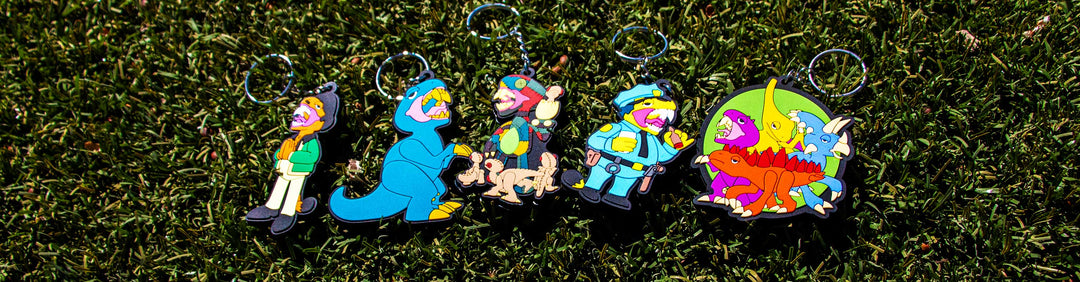 Wholesale Elbo Keychains laying down on grass outside office building