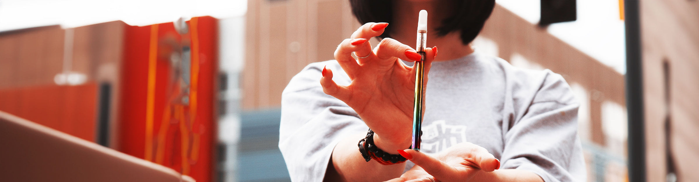 Colorful assortment of Wholesale oil cartridge vape pens on black fabric