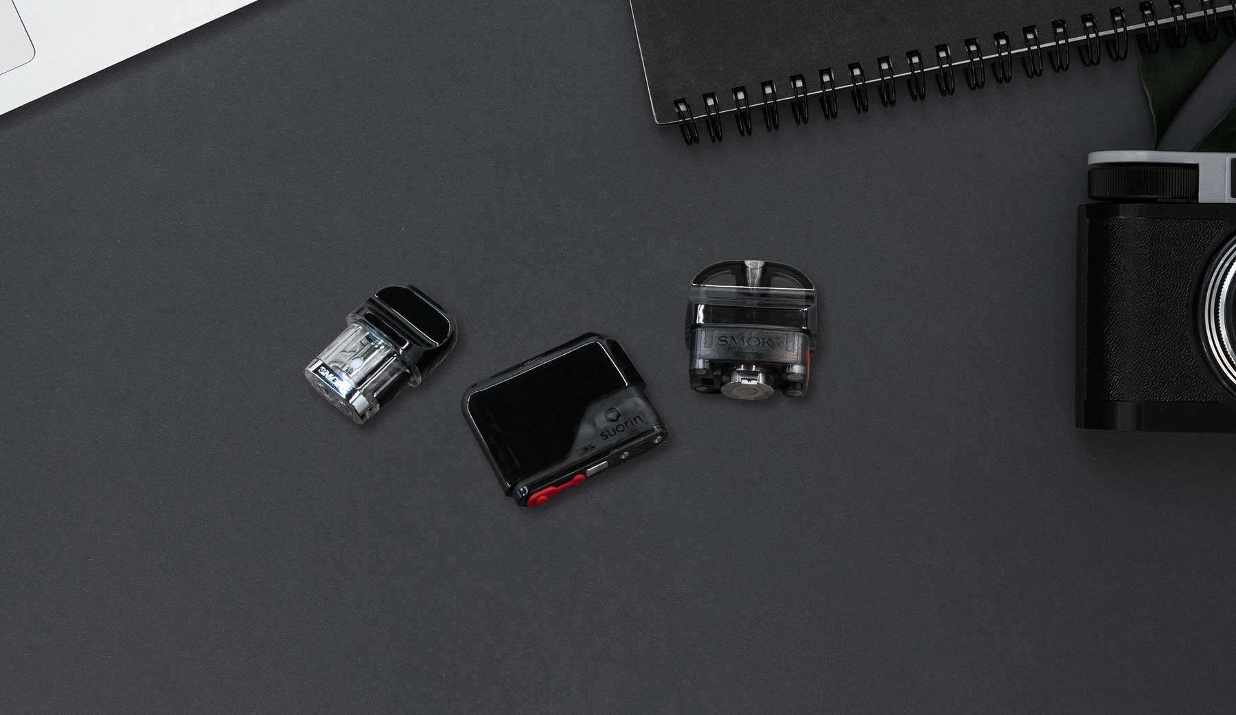 Wholesale Vape pods from various devices laid out on black background face up